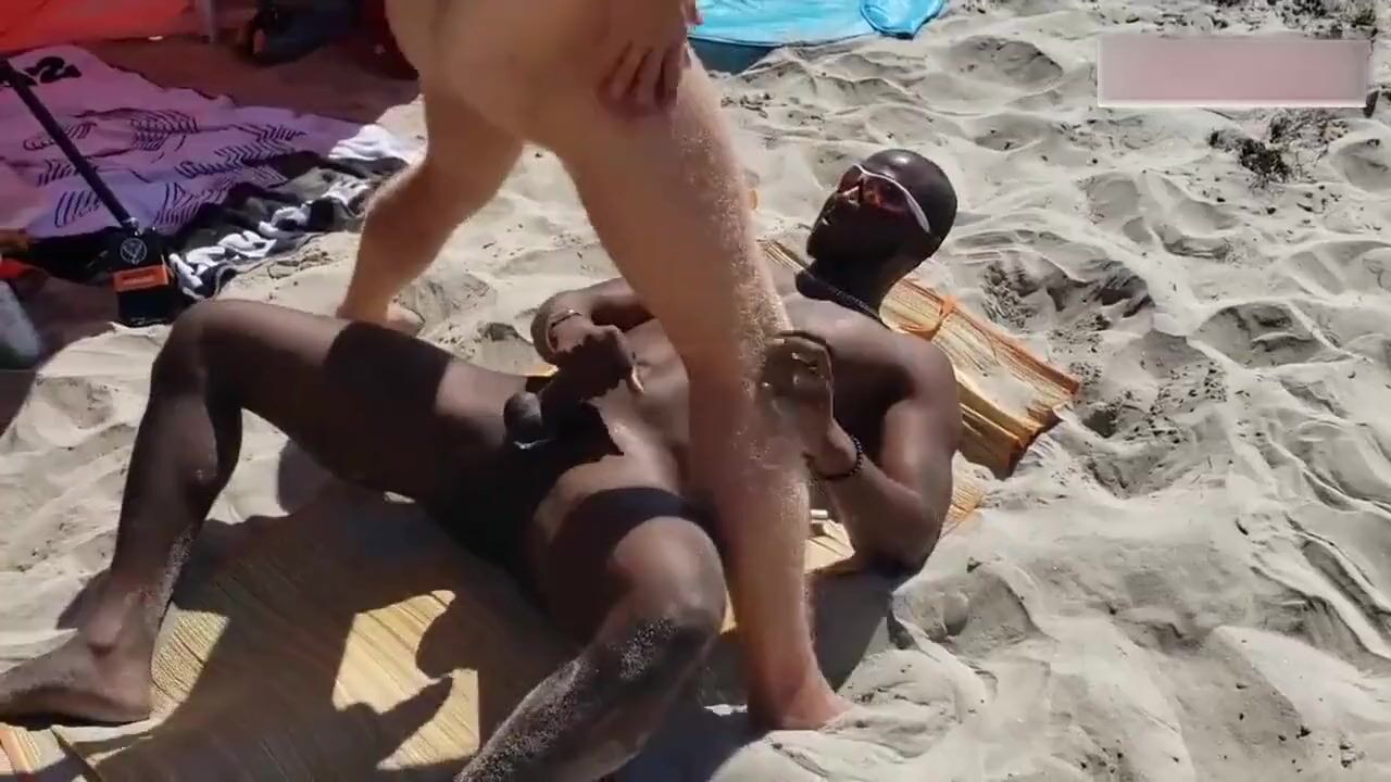 Black and white gay on a public beach